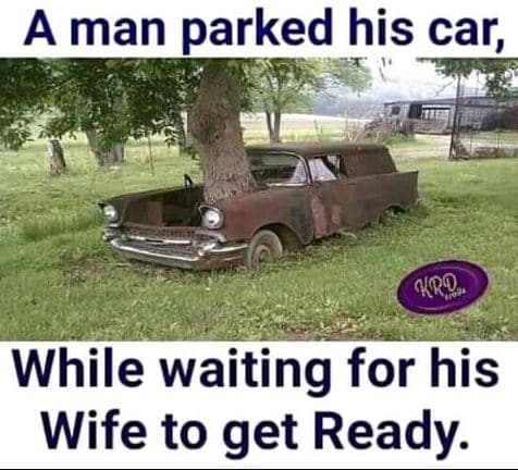 A man parked his car no . while waiting for his wife to get ready.